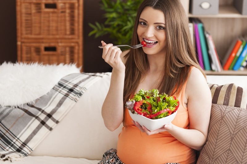 storyblocks pregnant smiling woman eating salad H goT06D5M - 5 Healthy Fruit Juices to Take During Pregnancy